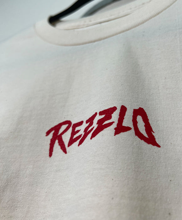 Cream shirt with red 'Rezzlo' logo